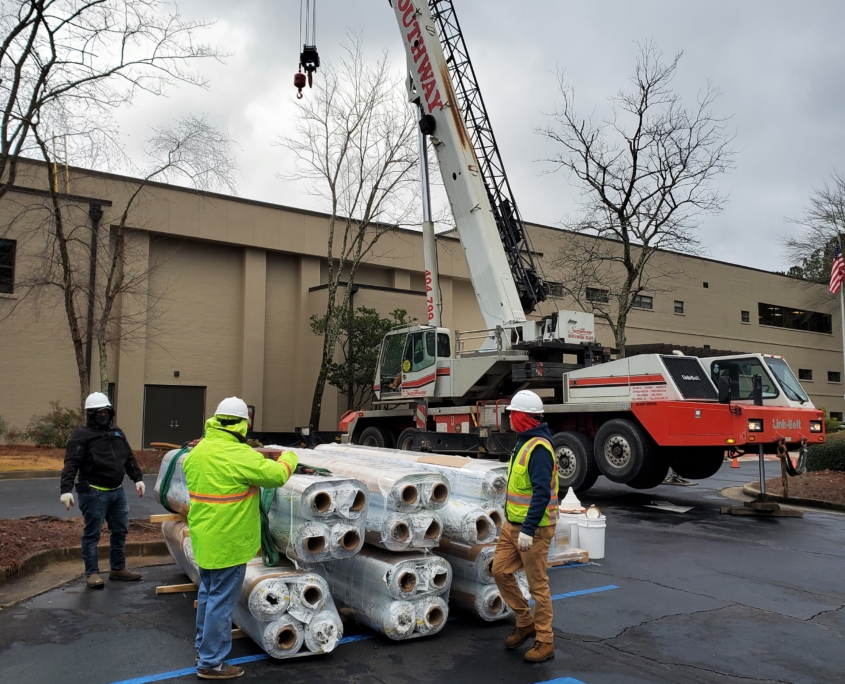 Workers lifting material on roof