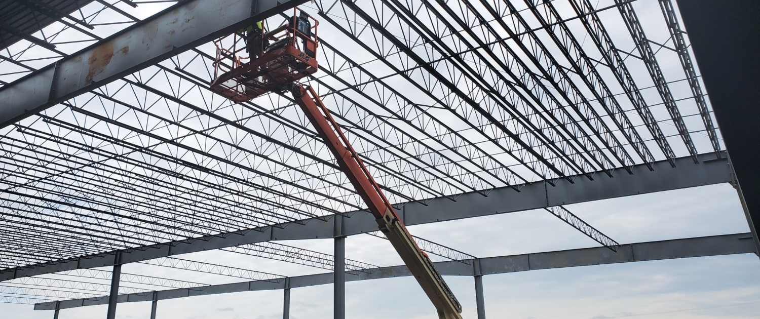 Worker in lift working on roof