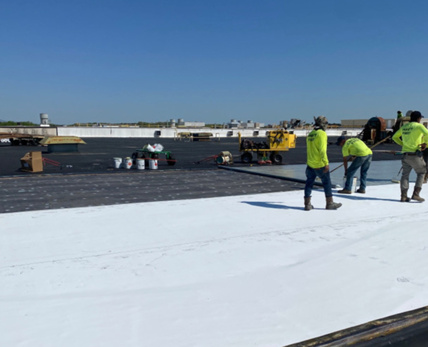 Workers on white flat roof