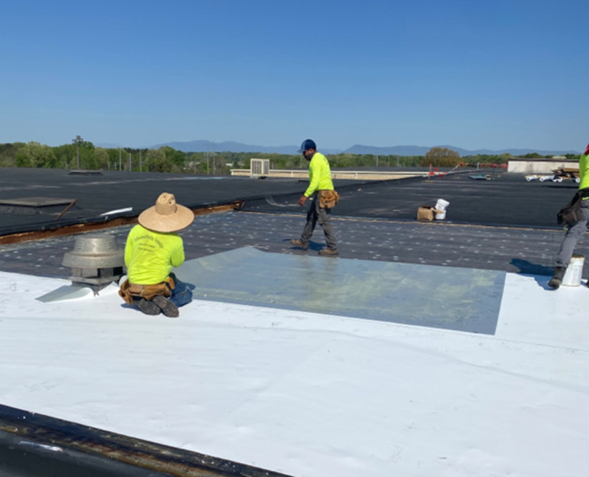 Workers on flat white roof